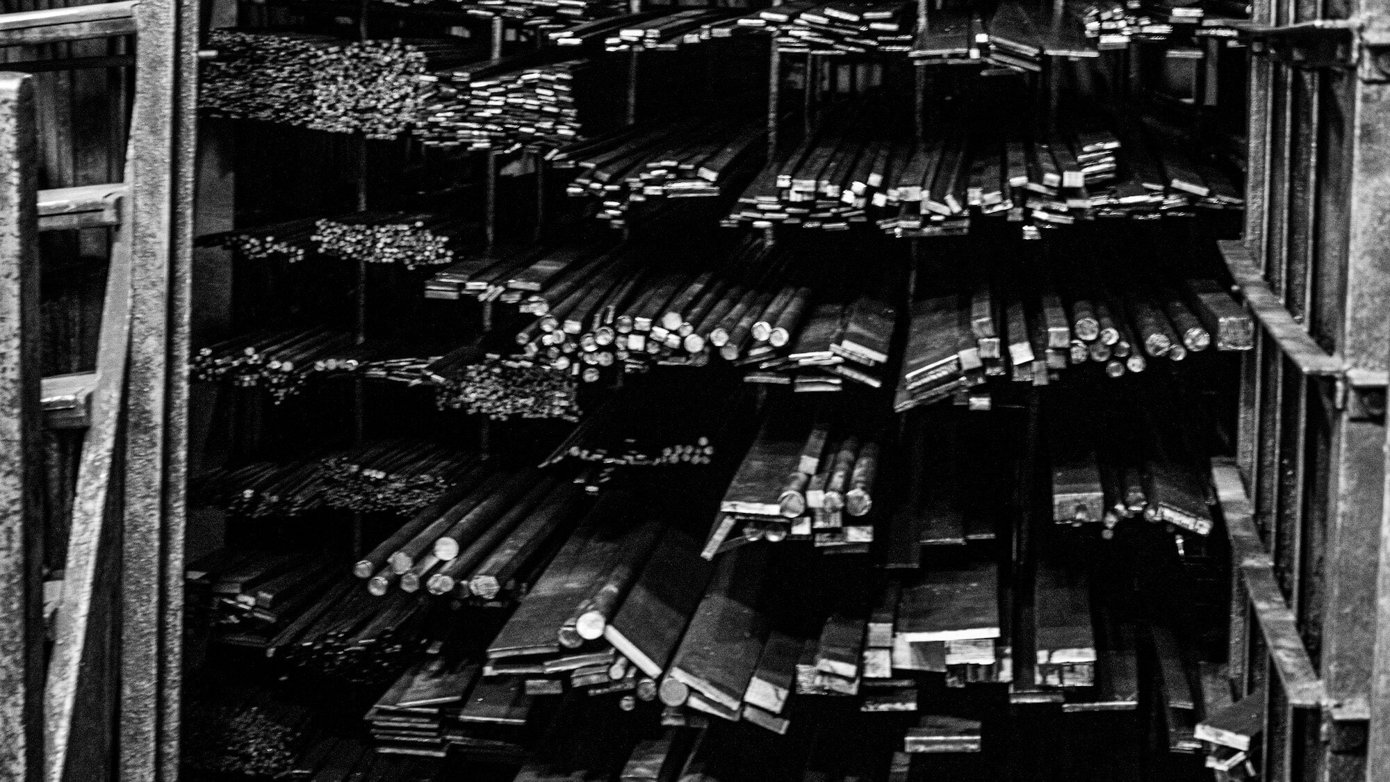Metal bars and profiles sorted on warehouse racks